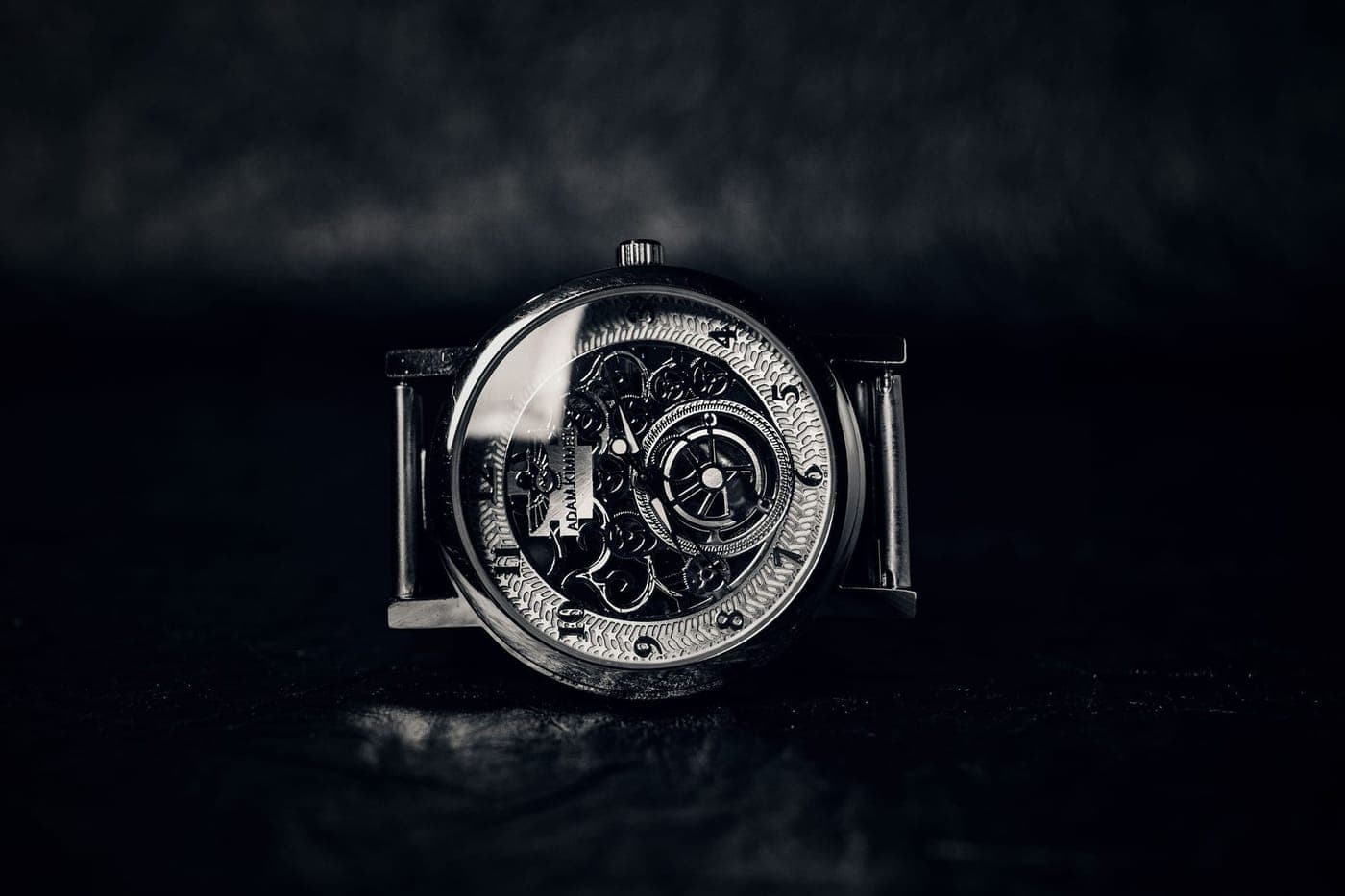 A skeleton mechanical wristwatch on a dark background